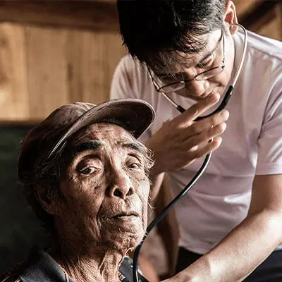Doctor examining Filipino man
