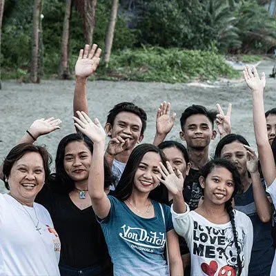Members of the aid organization waving at the camera
